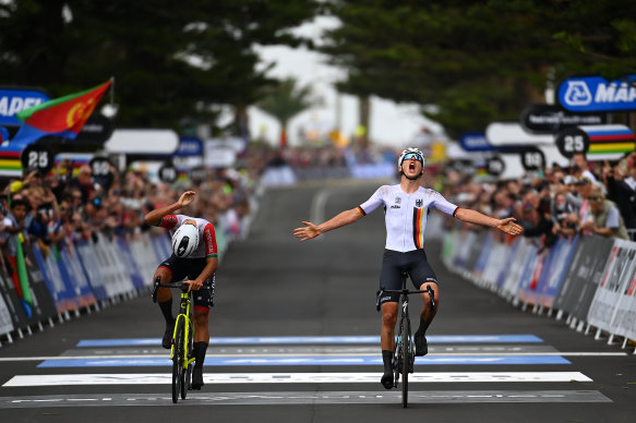 Emil Herzog of Germany celebrates at finish line near Wollongong’s City Beach, as winner of the junior road race.