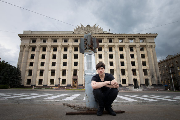 Oleksii Knyazkov with an unexploded rocket in front of Kharkiv city hall. 