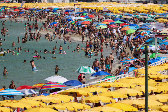 People cool off at Mondello beach in Palermo, during a heatwave across Italy in 2023.