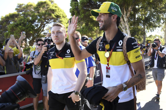 Renault's Daniel Ricciardo, right, waves to the crowd in Melbourne ahead of the Australian Grand Prix. 