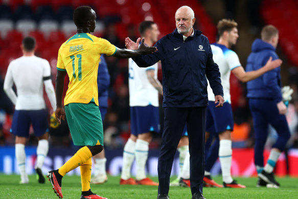 Socceroo Awer Mabil and coach Graham Arnold.