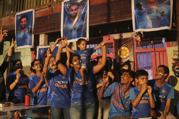 Fans in Mumbai cheer as they watch on television a 2015 World Cup match between India and Pakistan.