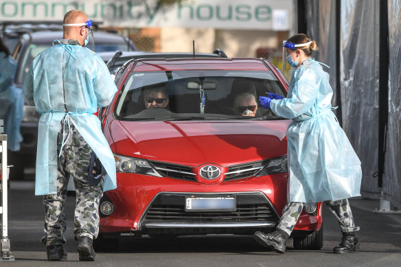 Australian Defence Force members, in uniform, joined Victorian health workers at testing sites in Melbourne on Saturday.