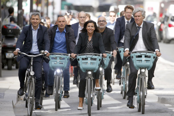 Paris Mayor Anne Hidalgo leads the 15-minute city charge down a bike path on the Rue de Rivoli, part of her plan to have 15 per cent of city trips made by bicycle.