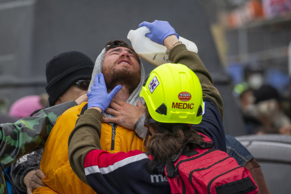 A demonstrator receives medical attention in Wellington after he was sprayed by police on Wednesday. 