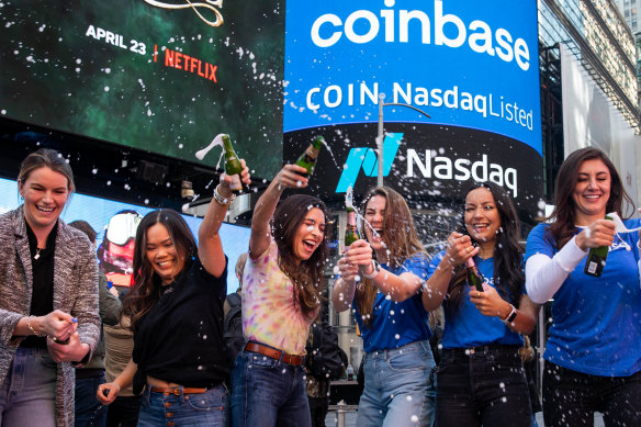 Coinbase employees celebrate during the company’s initial public offering outside the Nasdaq MarketSite in New York.