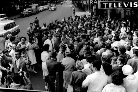 Pitt St was almost deserted when this crowd spilled on to the roadway 
outside Levenson's shop to watch the Centenary Melbourne Cup telecast.
There was no explanation for the elation of the man on the left, November 1, 1960.