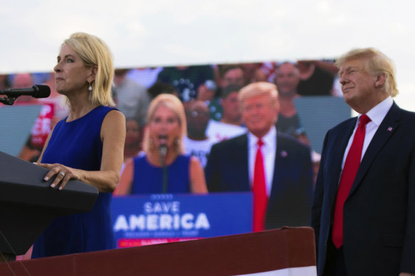 Congresswoman Mary Miller speaks as former president Donald Trump stands behind her on stage at a rally at in Mendon, Illinois.