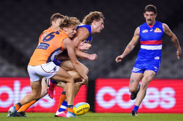 Aaron Naughton collects Lachie Whitfield. The GWS star suffered concussion.