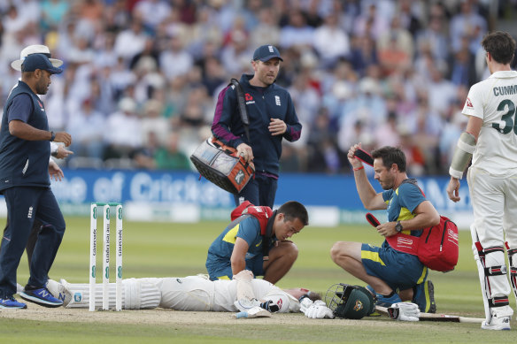 Smith receives treatment after being hit on the head by a Jofra Archer delivery during the Ashes in 2019.