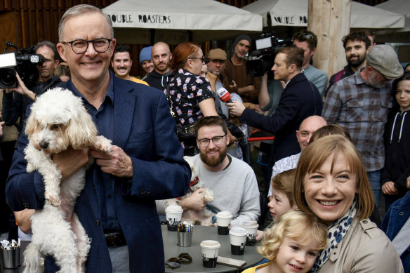 Transport Minister Jo Haylen (right) with Kieren Ash who is sitting with a dog and Prime Minister Anthony Albanese the morning after the federal election last year.