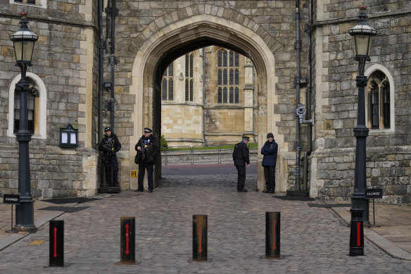 Police guard the Henry VIII gate to Windsor Castle, England. A man was charged with intent to “injure or alarm” the Queen after being arrested at the castle on Christmas Day 2021.