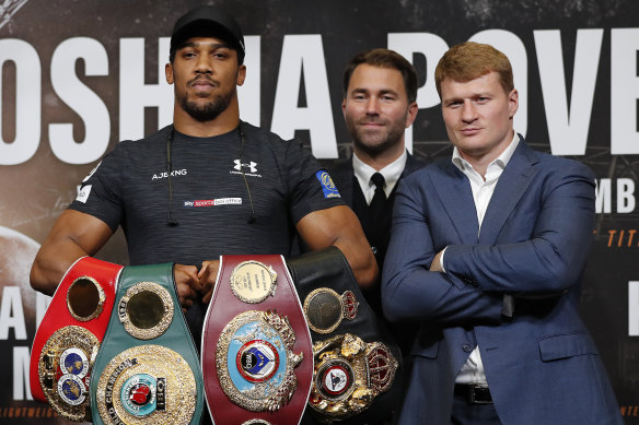 Britain's Anthony Joshua (left) and Russia's Alexander Povetkin (right) with promoter Eddie Hearn before a title fight in 2018.