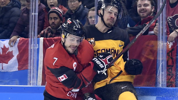 Canada forward Gilbert Brule checks Germany defenceman Moritz Muller into the boards.