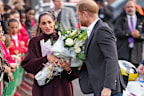 Meghan, Duchess of Sussex holds a bouquet of flowers as she and Prince Harry, Duke of Sussex arrive at the Community Recording Studio (CRS),