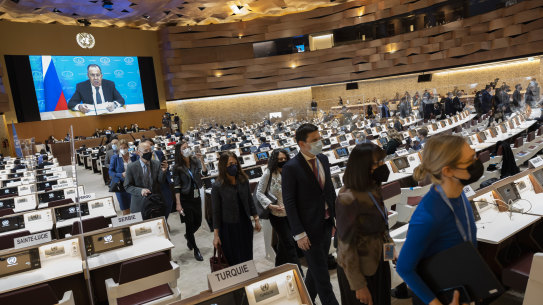 Ambassadors and diplomats leave the room while Russia’s foreign minister Sergei Lavrov (on screen) addresses with a pre-recorded video message the Conference on Disarmament in Geneva on Tuesday.