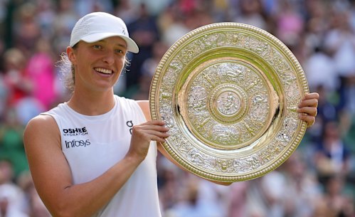 Poland’s Iga Swiatek holds the trophy after beating Amanda Anisimova to win the women’s singles final.
