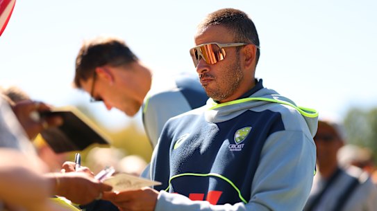 Usman Khawaja signs autographs on what should have been day three of the Boxing Day Test.