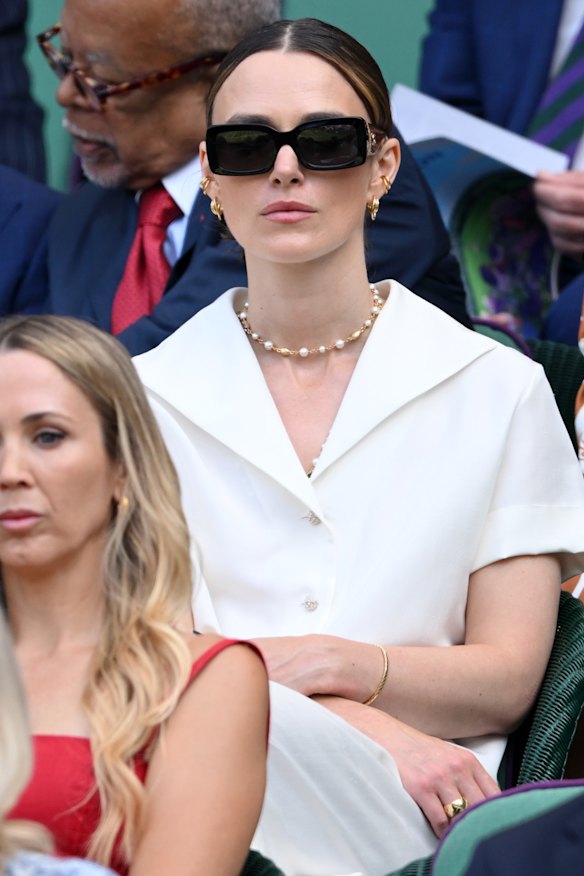 Keira Knightley paired sophisticated tennis whites with pearl jewellery and black sunglasses.