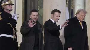 French President Emmanuel Macron, center, President-elect Donald Trump, right, and Ukraine’s President Volodymyr Zelenskyy leave after their meeting at the Elysee Palace, Saturday in Paris