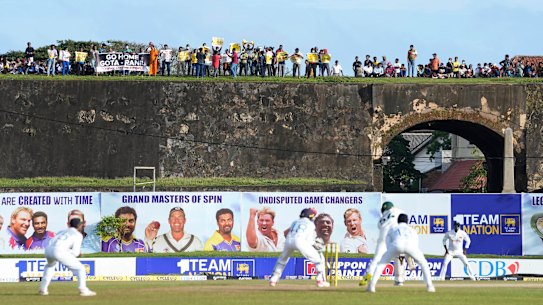 Protest signs were visible on the fort ramparts in Galle on day two of the Test match as Australia batted.