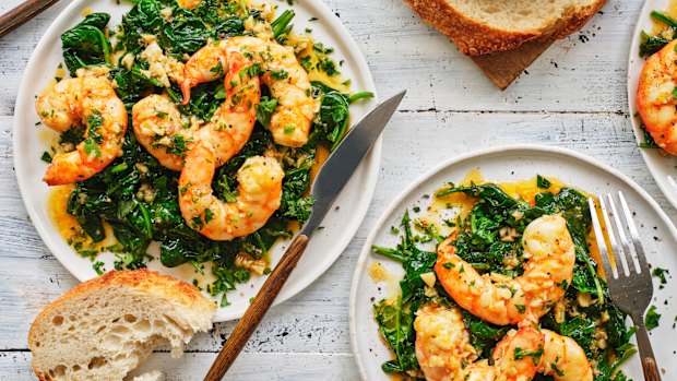 Garlic-butter and white-wine prawns over wilted spinach.