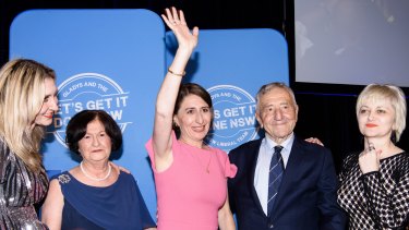 Premier Gladys Berejiklian, flanked by her family, arrives at the Sofitel Wentworth in Sydney on election night 2019.