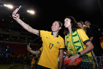 Kyah Simon poses with fans after the second international against the USA in Newcastle.