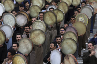 Musicians from the Kurdish western region of Iran play Daf, a hand-held Persian drum, in a ceremony ahead of the Iranian New Year, or Nowruz, at a park in Tehran, Iran, on Monday.