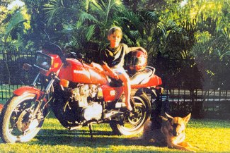 Cassidy on his dad’s motorbike in his family’s Shorncliffe backyard with Winny the German shepherd.