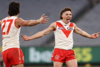 Errol Gulden and the Swans celebrate a goal in round 20.