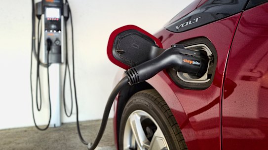 A hybrid car at a charging station.