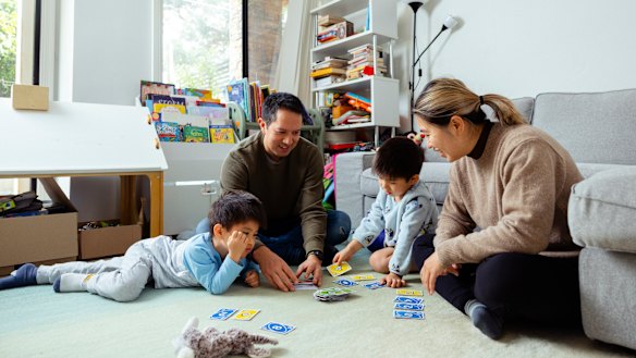 Play time: Connie Tao Li and David Chan with their twin sons Finley and Miles (right) who have no regular screen time. 