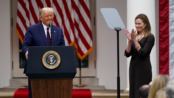 Judge Amy Coney Barrett applauds as President Donald Trump announces Barrett as his nominee.