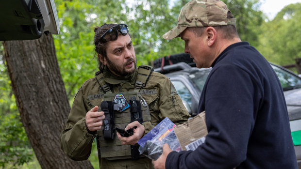 A Ukrainian civilian volunteer brings supplies to troops near a frontline position. 