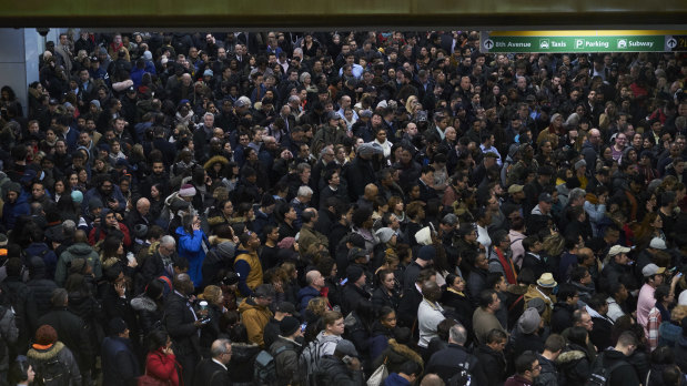 Commuters wait in long lines at the Port Authority Bus Terminal in Manhattan.