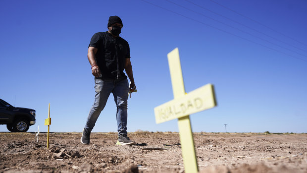 Hugo Castro leaves crosses at the scene of a deadly crash in Holtville, California. 