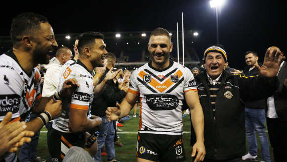 Guard of honour: Farah leaves the field on Friday night with his proud father Peter.