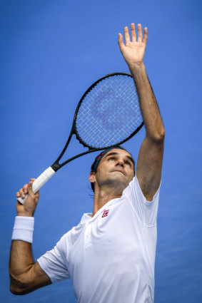 Federer fires down a serve.