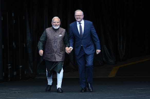 Indian Prime Minister Narendra Modi, (left) and Australian Prime Minister Anthony Albanese walk out onto the field at the Melbourne Cricket Ground.