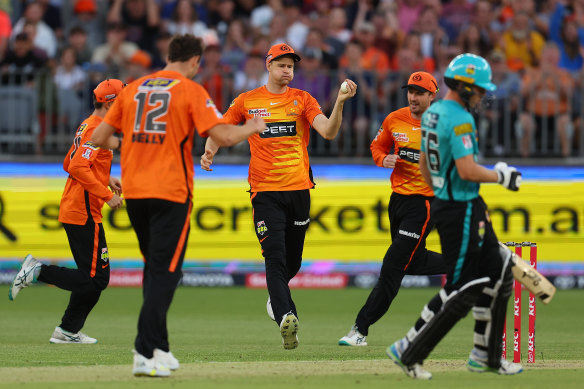 Jason Behrendorff of the Scorchers celebrates after taking a catch during the Men’s Big Bash League match against the Heat at Optus Stadium on Wednesday.