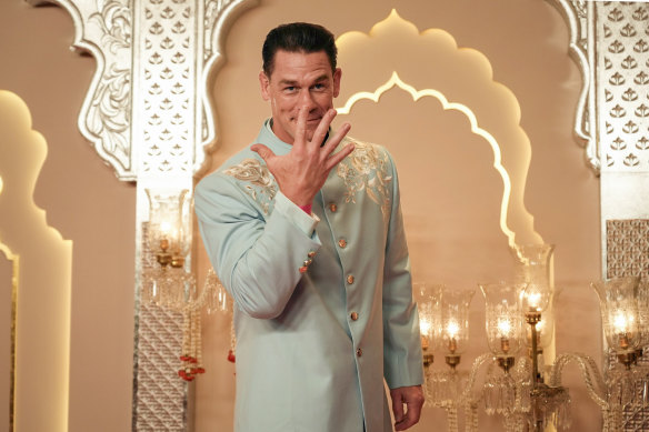 American actor and professional wrestler John Cena gestures as he arrives at the wedding.