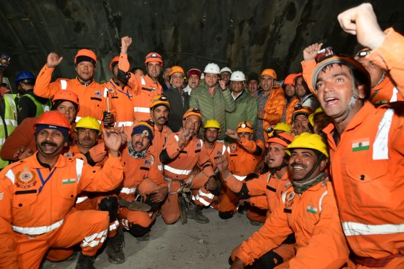 The rescued workers cheer after being freed.