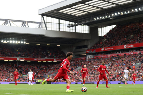 Trent Alexander-Arnold runs with the ball in front of a full house at Anfield.