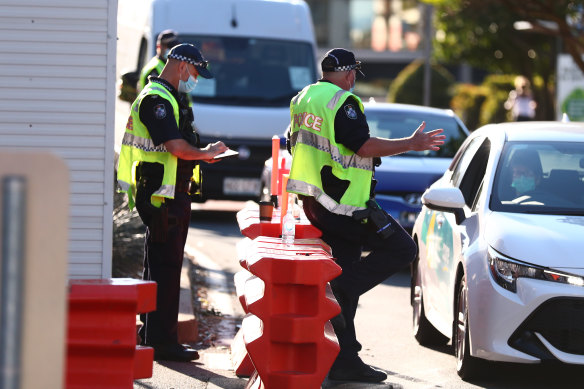 Queensland Police stop cars at the Griffith Street checkpoint in Coolangatta on August 25.