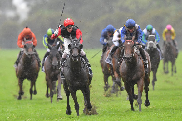 Con Te Partiro (red and black) gets the cash in the Coolmore Classic.