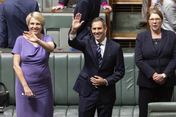 Treasurer Jim Chalmers waves to people in the gallery before delivering the budget speech on Tuesday evening.