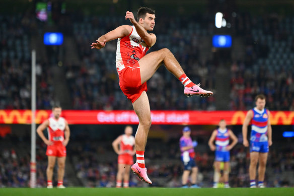 Logan McDonald kicks a set-shot goal for the Swans.