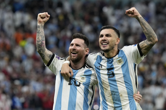 Argentina’s Lionel Messi (left) and Leandro Paredes celebrate their quarter-final victory.