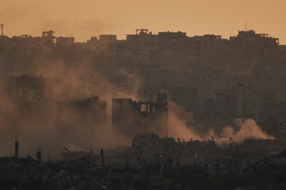 Smoke rises over the ruins of destroyed buildings in northern Gaza on Tuesday.